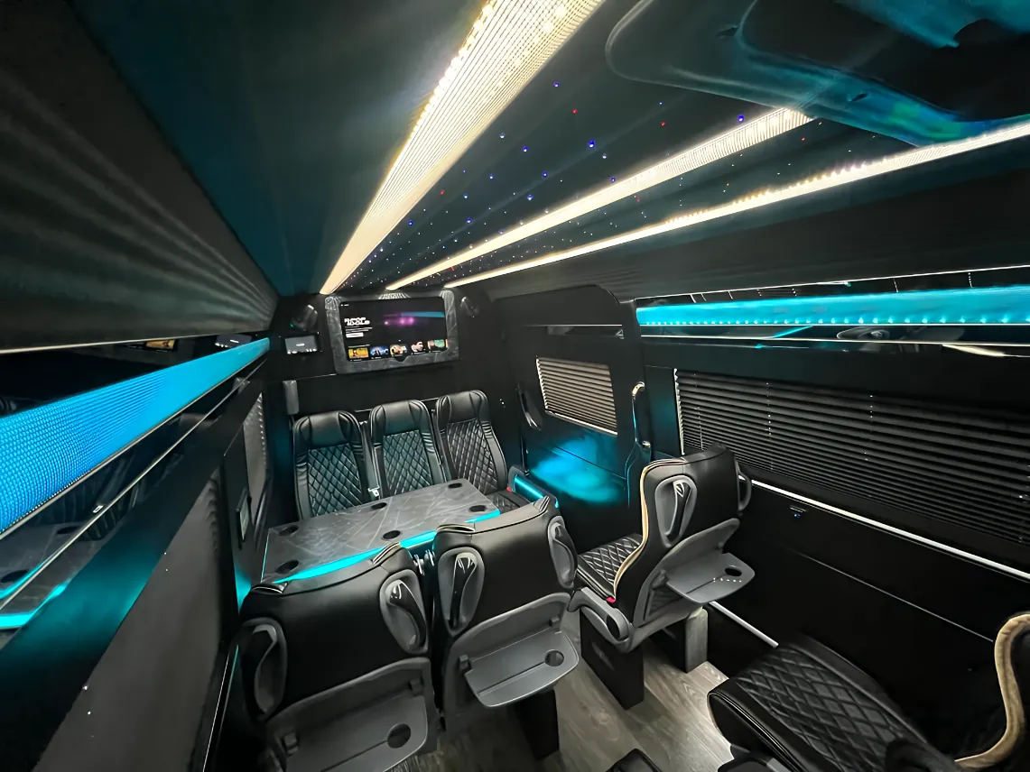Forward-facing leather seats inside Executive Sprinter van for small corporate executive group