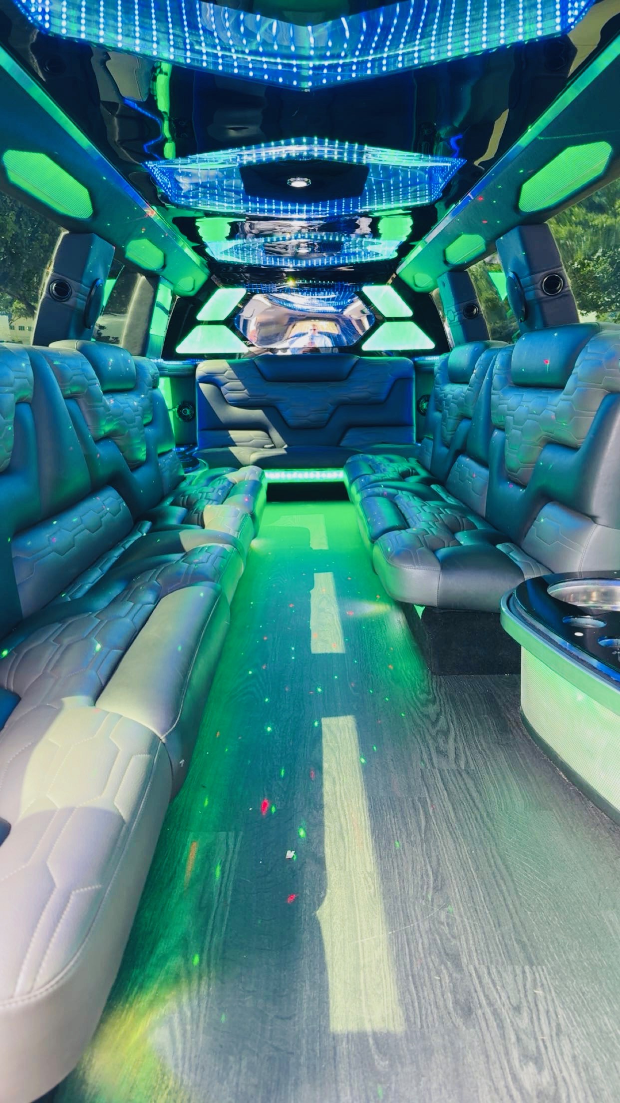 Interior of 2024 Cadillac Escalade stretch limousine with premium leather seating and LED lighting