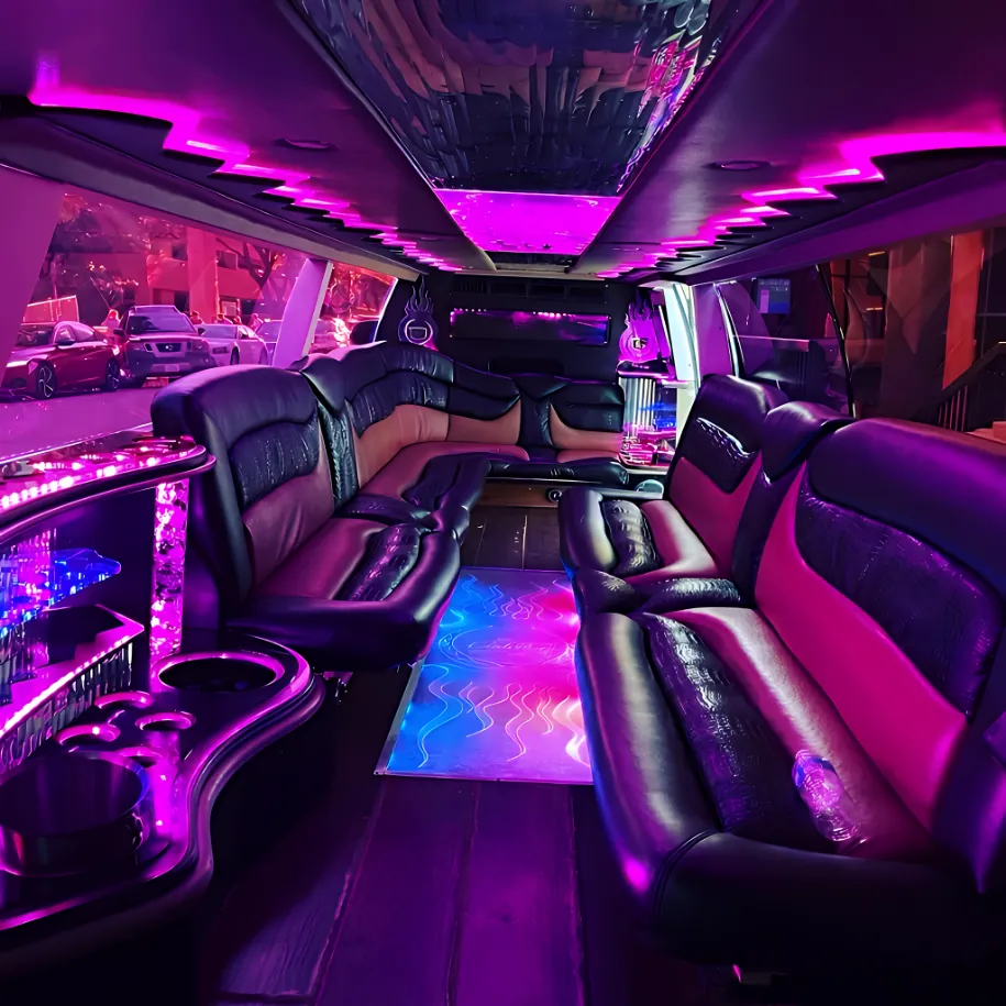 Interior of black 18-passenger Cadillac Escalade stretch limousine with leather seating