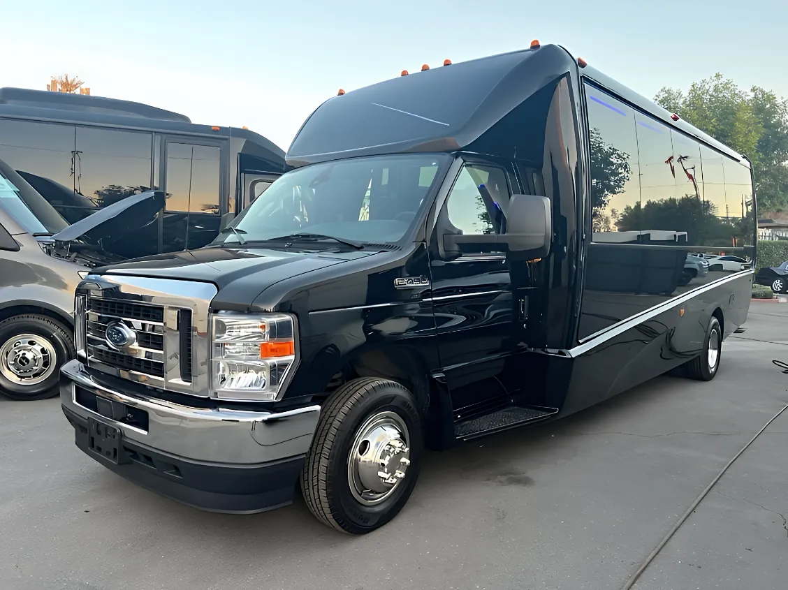 White 25-passenger executive minibus exterior for DFW employee shuttle and group airport transfer