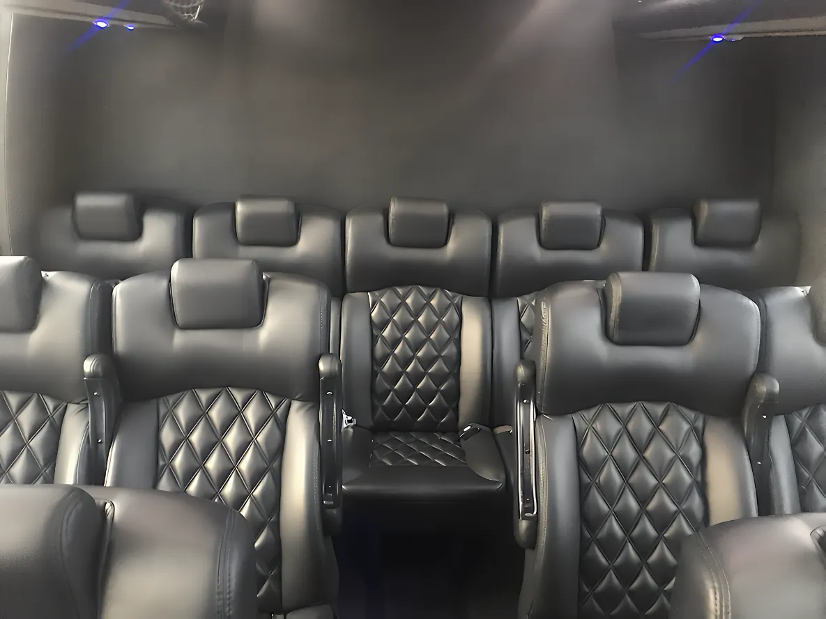Forward-facing row seating inside a 25-passenger executive minibus for corporate and event shuttling