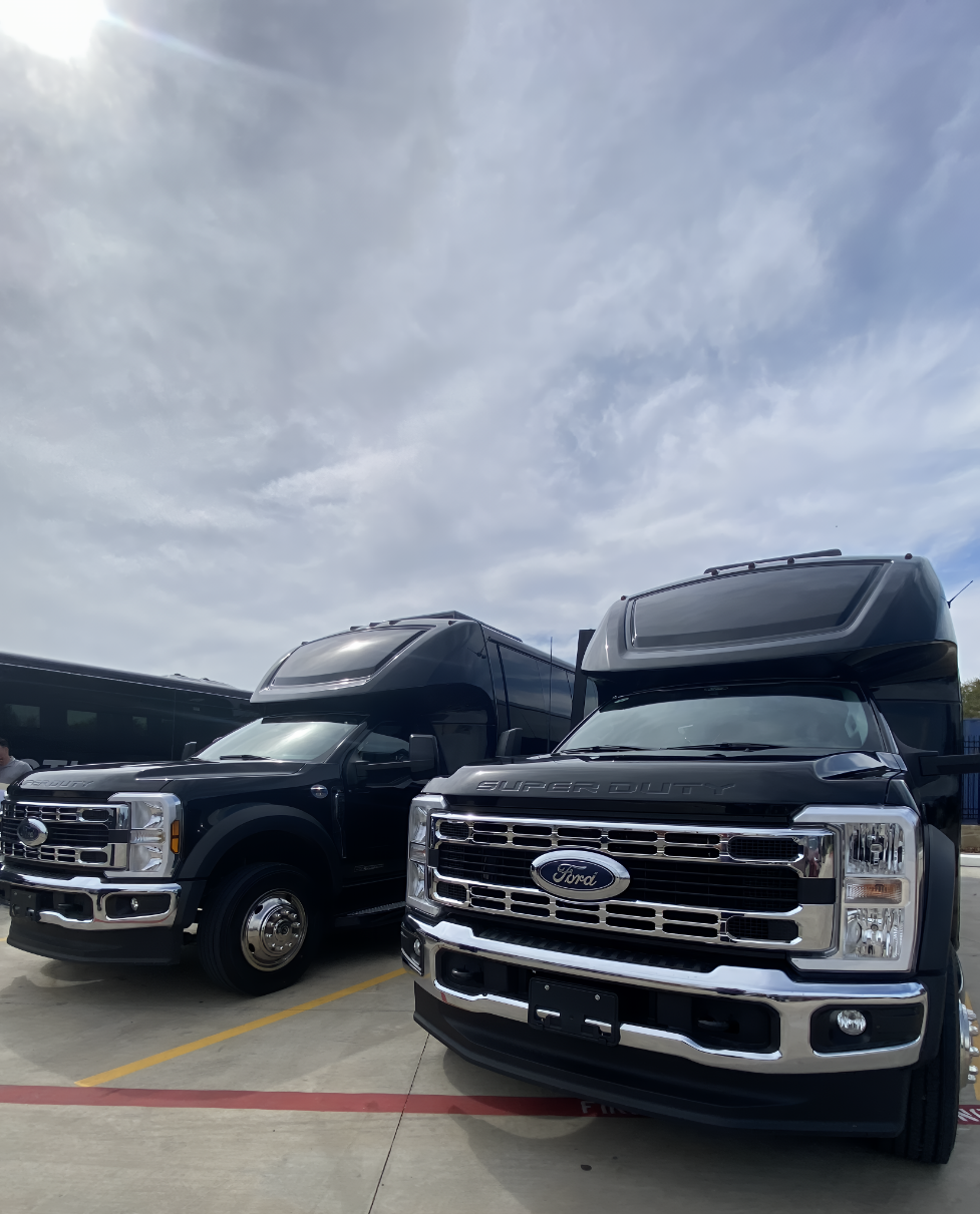 Black 31-passenger executive bus staged outside a venue ready for corporate group pickup in DFW
