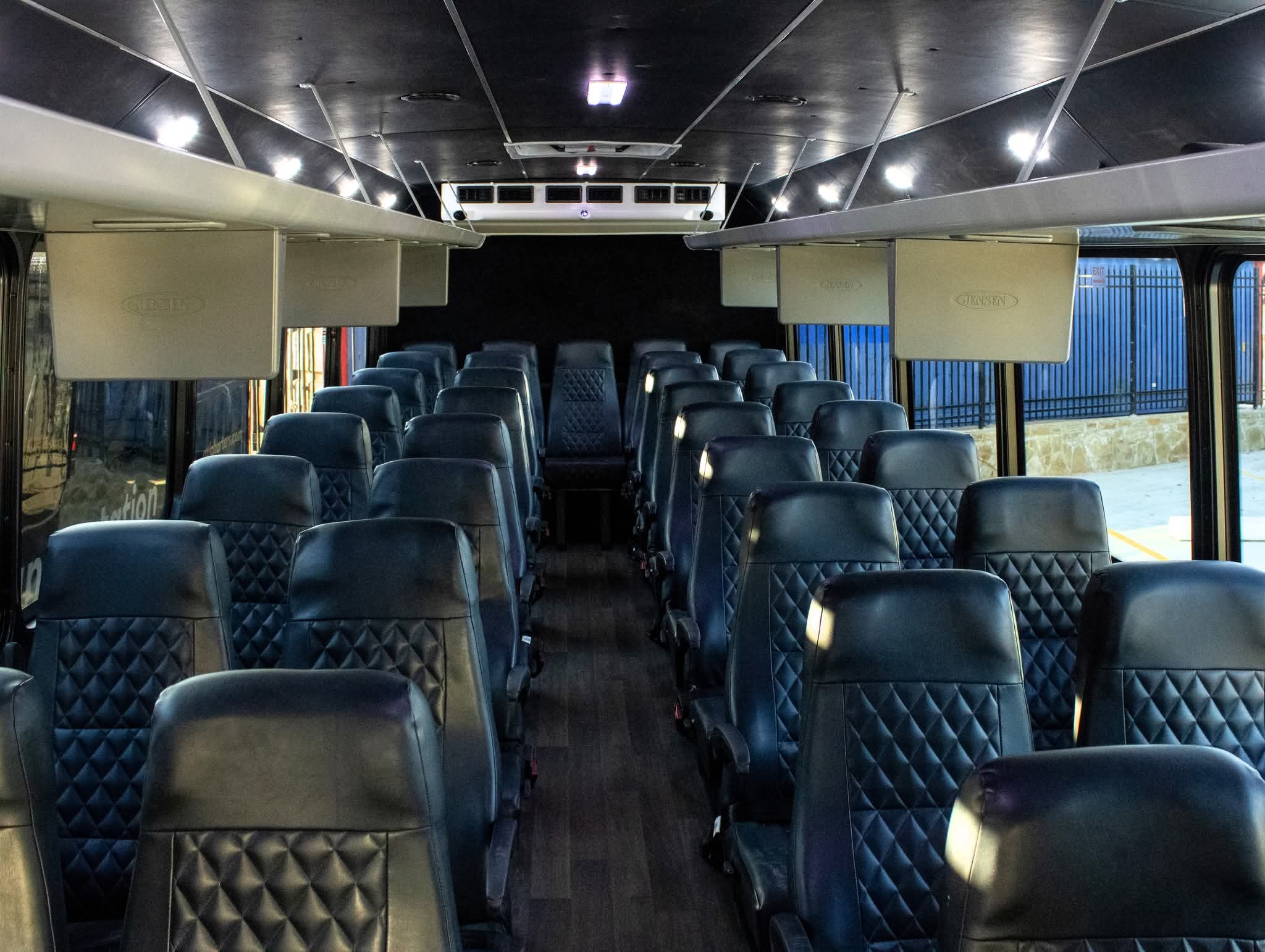 Premium leather captain's chair seating inside 34-38 passenger executive bus