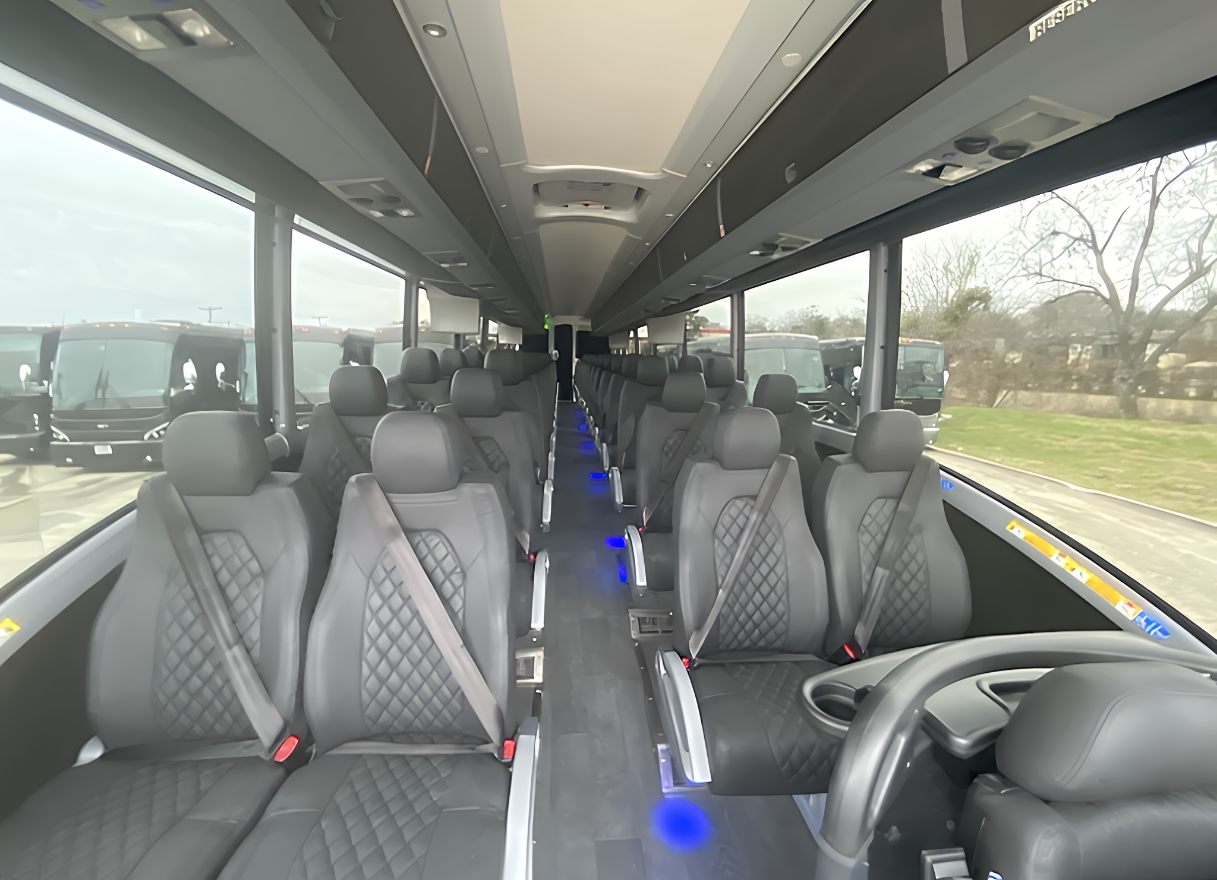Forward-facing reclining seats inside 56-passenger motorcoach for corporate group travel