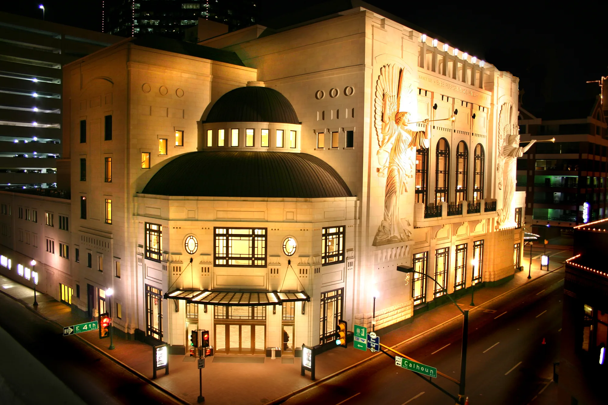 Bass Performance Hall lit at night in downtown Fort Worth, with the limestone angels on the Commerce Street facade — QTS Black Car & Limo transportation for September 2026 events