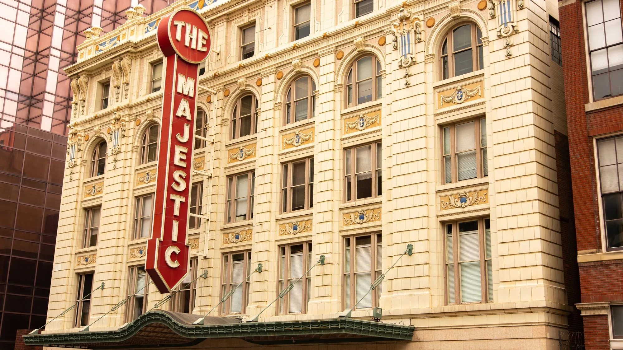 The Majestic Theatre's vertical marquee and terra cotta facade on Elm Street in downtown Dallas — QTS Black Car & Limo transportation for September 2026 events