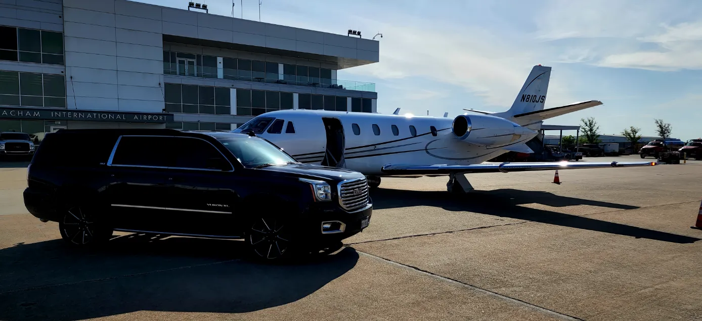 Private FBO tarmac pickup with a black GMC Yukon XL at McKinney National Airport