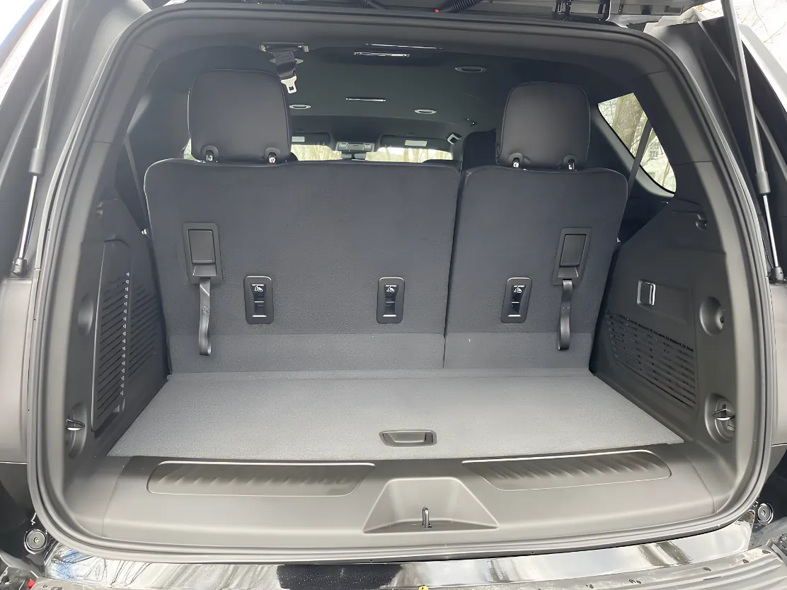 GMC Yukon XL with open trunk showing cargo capacity for golf clubs and executive luggage in Argyle TX